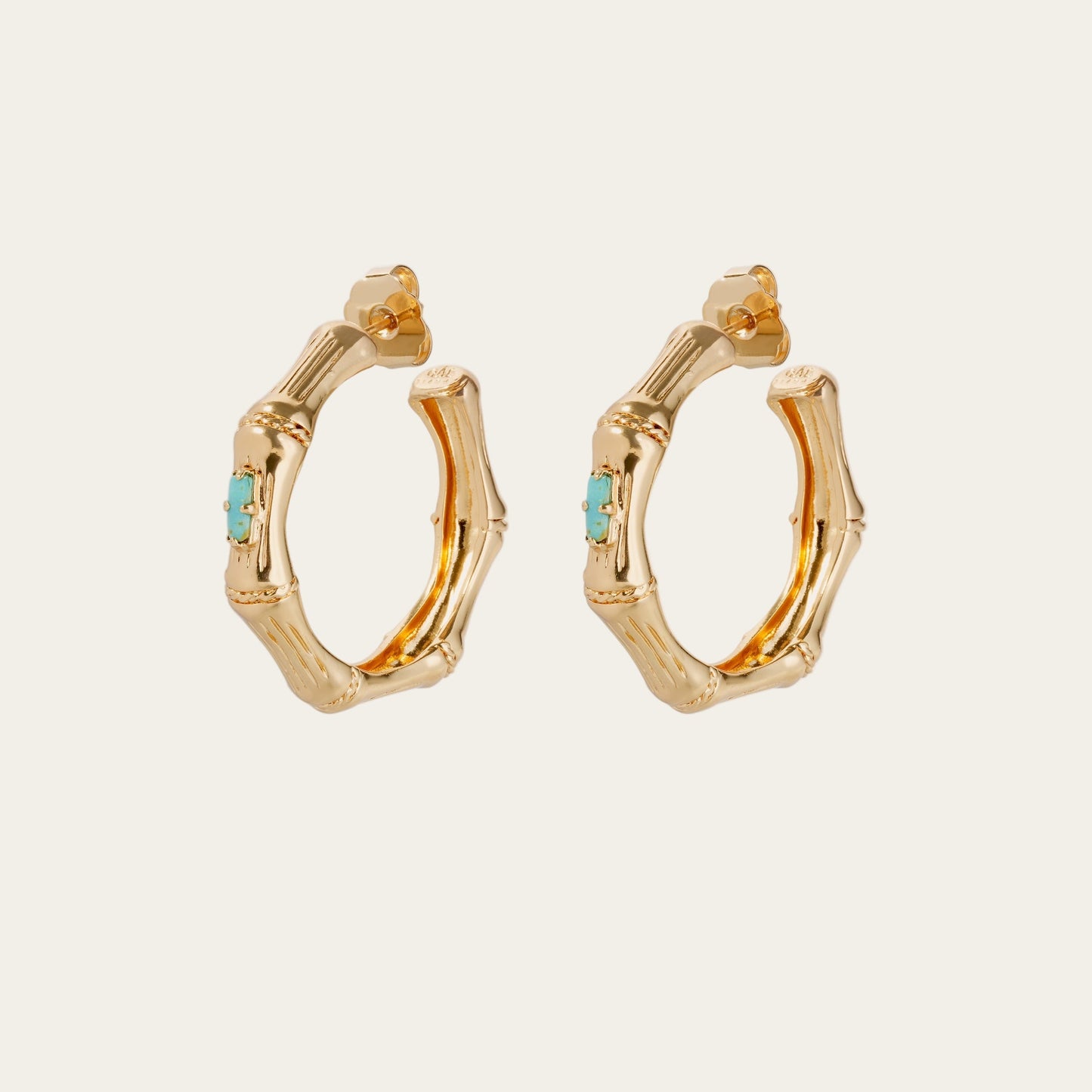 Gold hoop earrings with turquoise stones on a white background