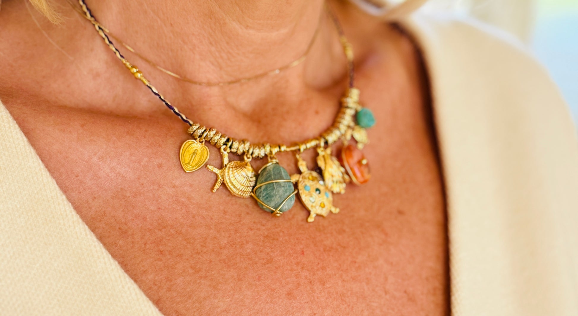Necklace with various charms worn by a person