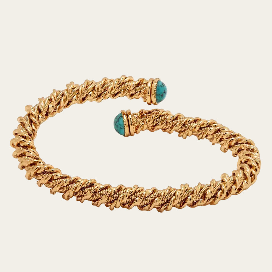 Gold bracelet with turquoise beads on a white background