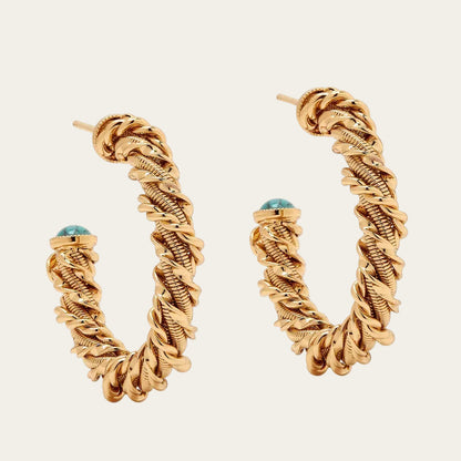 Gold hoop earrings with a textured design on a white background
