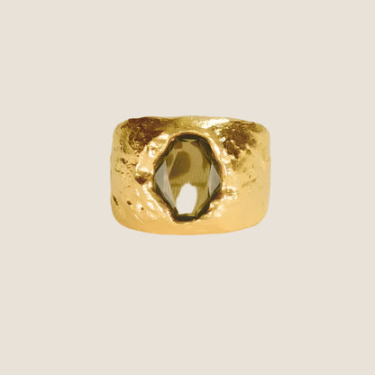 gold plated chunky, sculptural gold,green stone in centre,  flat lay