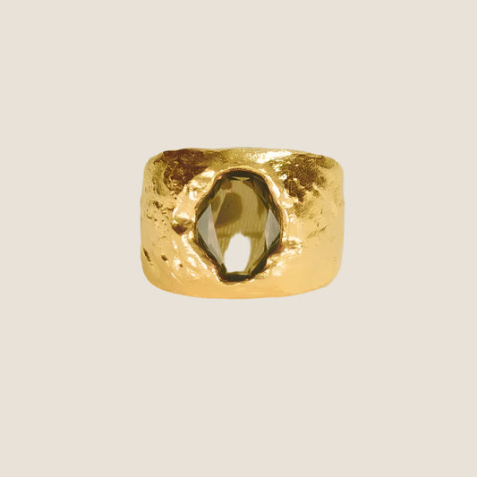 gold plated chunky, sculptural gold,green stone in centre,  flat lay
