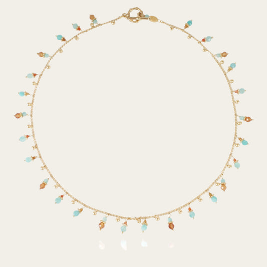 A gold-plated necklace with a series of tangerine-colored gemstone pendants and small pearls.