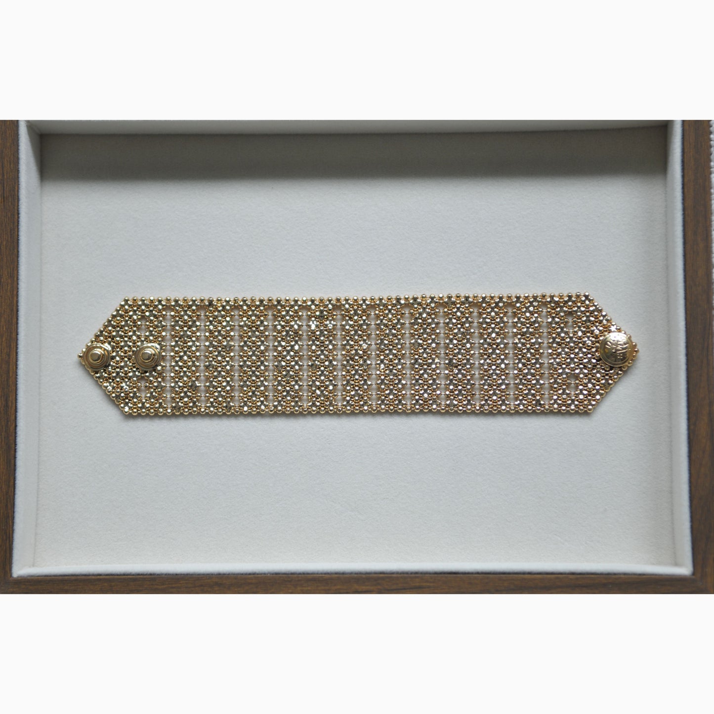 Gold bracelet on a white background