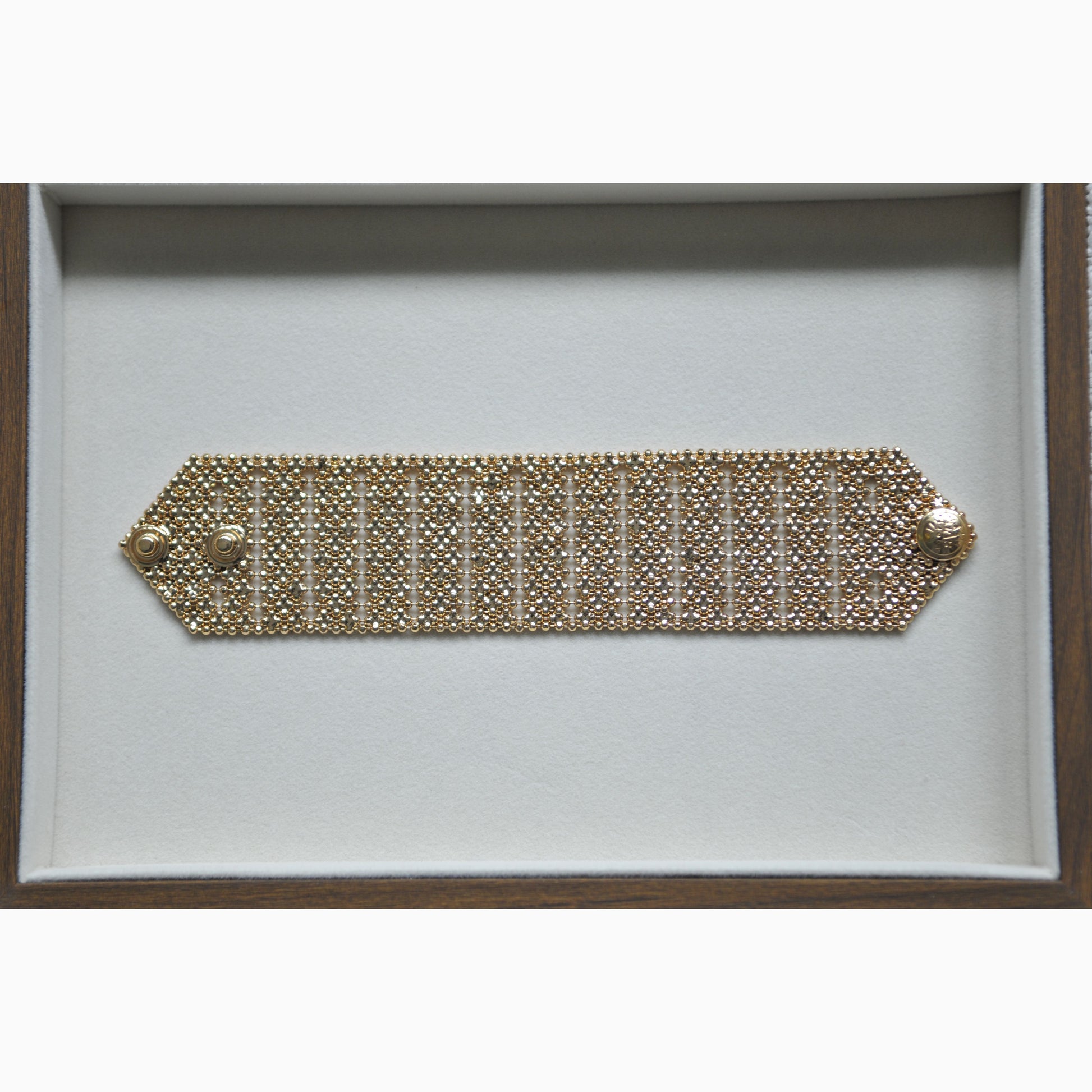 Gold bracelet on a white background