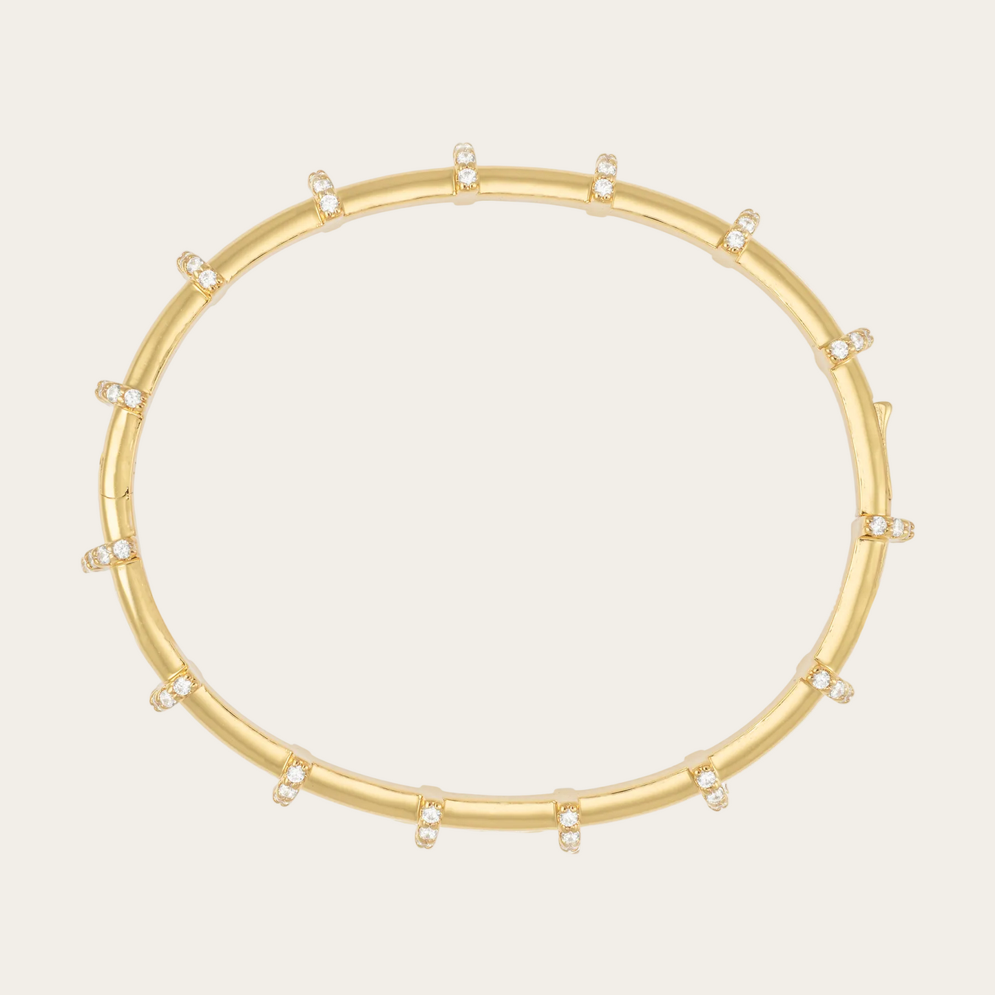 Gold bracelet with small diamonds on a white background