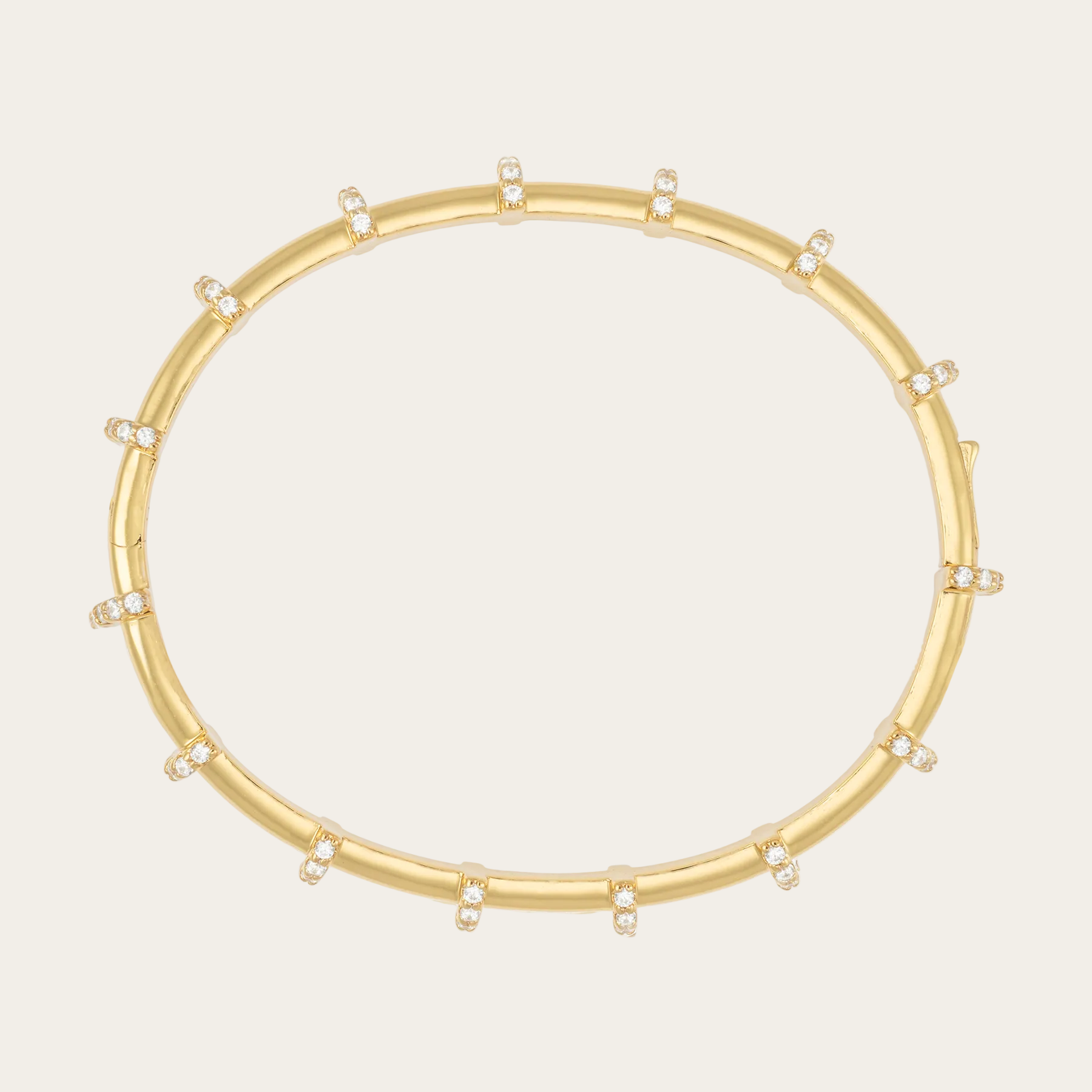 Gold bracelet with small diamonds on a white background