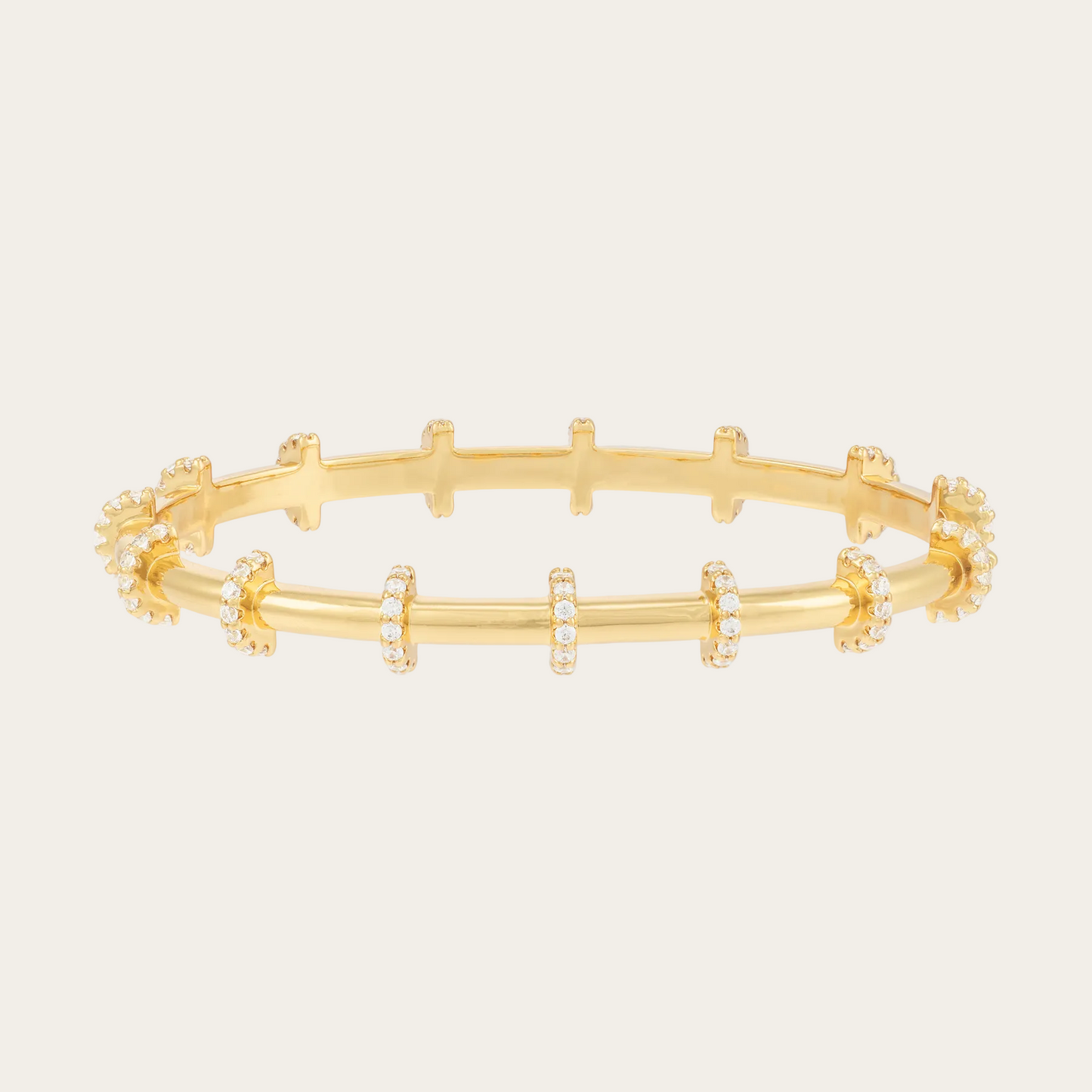 Gold bracelet with small zirconias on a white background