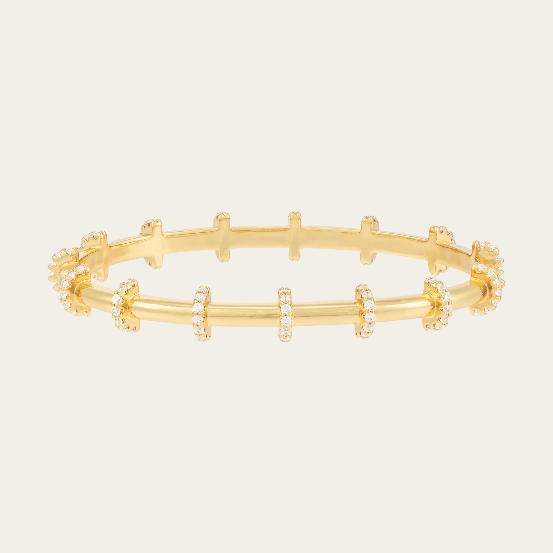 Gold bracelet with small zirconias on a white background