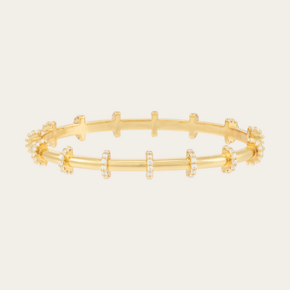 Gold bracelet with small zirconias on a white background