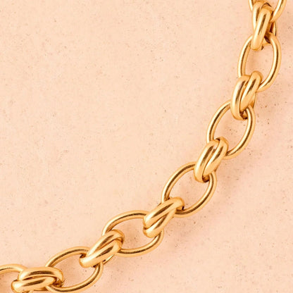 Gold chain on a beige background