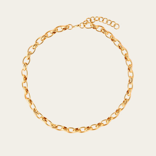 Gold chain bracelet on a beige background