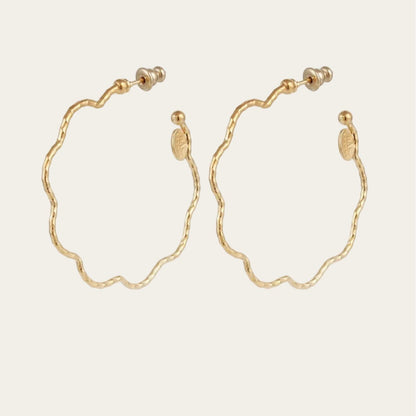 Gold hoop earrings on a white background