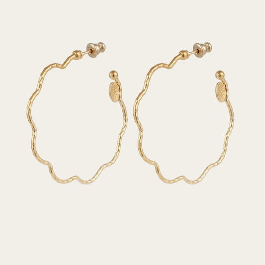 Gold hoop earrings on a white background