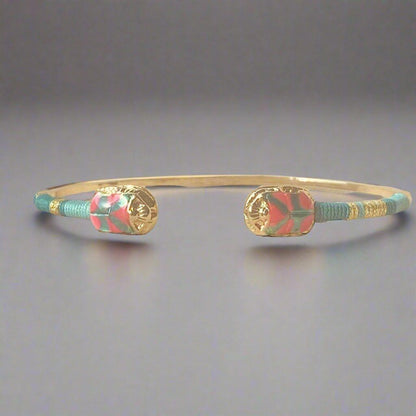 gas bijoux duality bangle pink & green on flat lay surface with light grey background