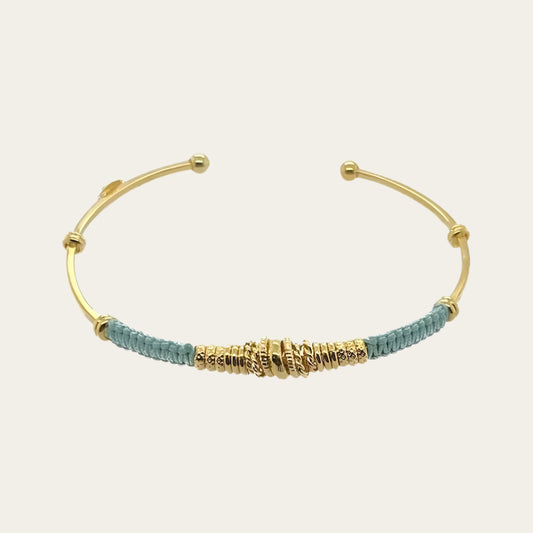 With a circumference of 15cms and a width of 0.4cms, this gold plated bangle with green coloured threads is available at The Artemis Edit