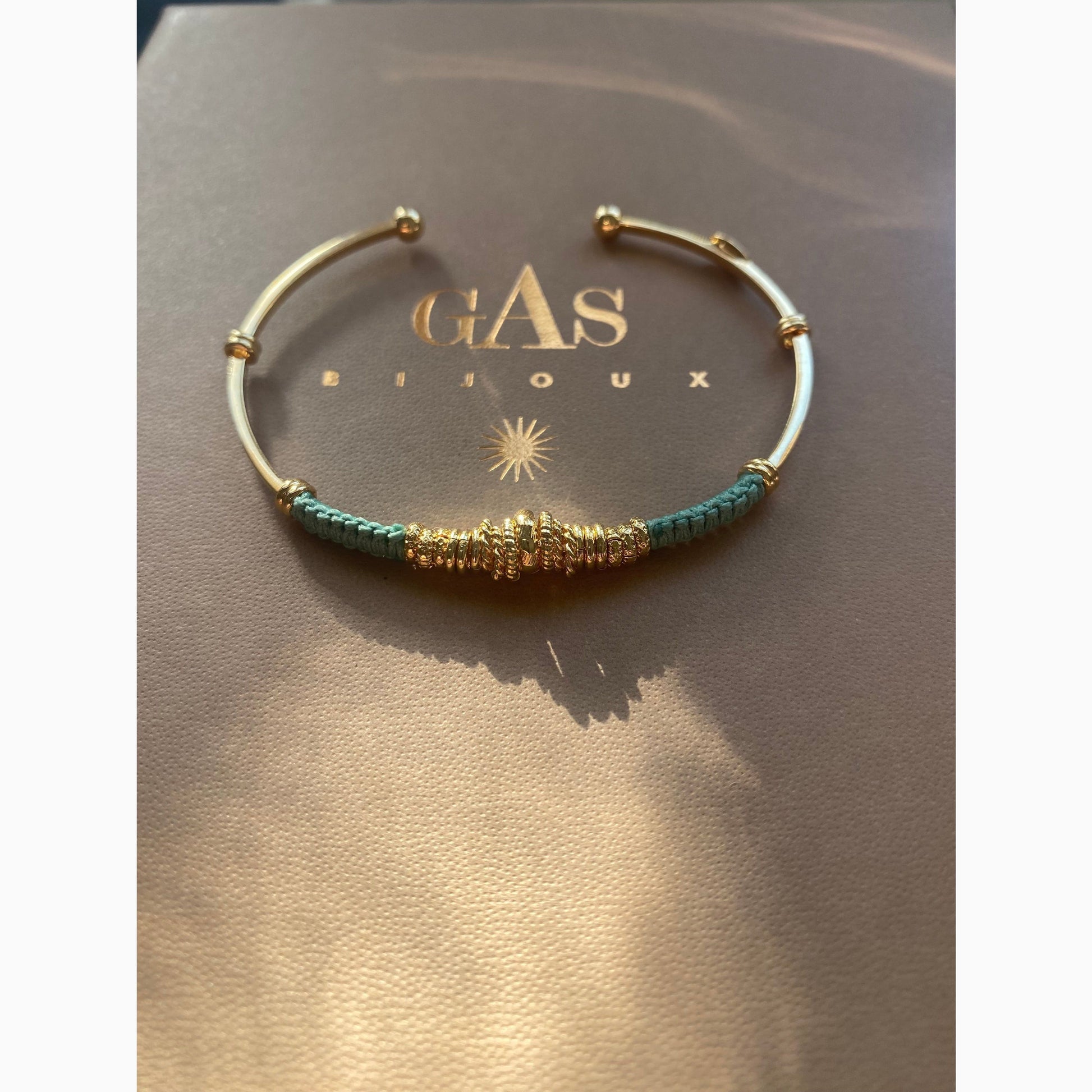 Gas Bijoux Zizanie bracelet in gold-plated finish, sculptural open cuff with twisted detail, styled on neutral background
