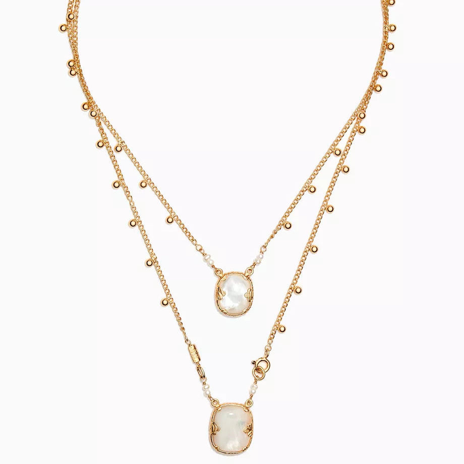 Gold necklace with a central pendant on a white background