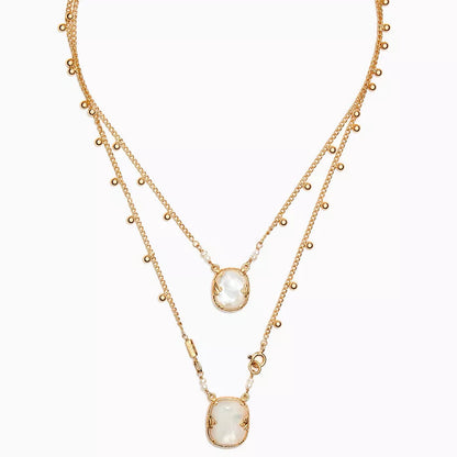 Gold necklace with a central pendant on a white background