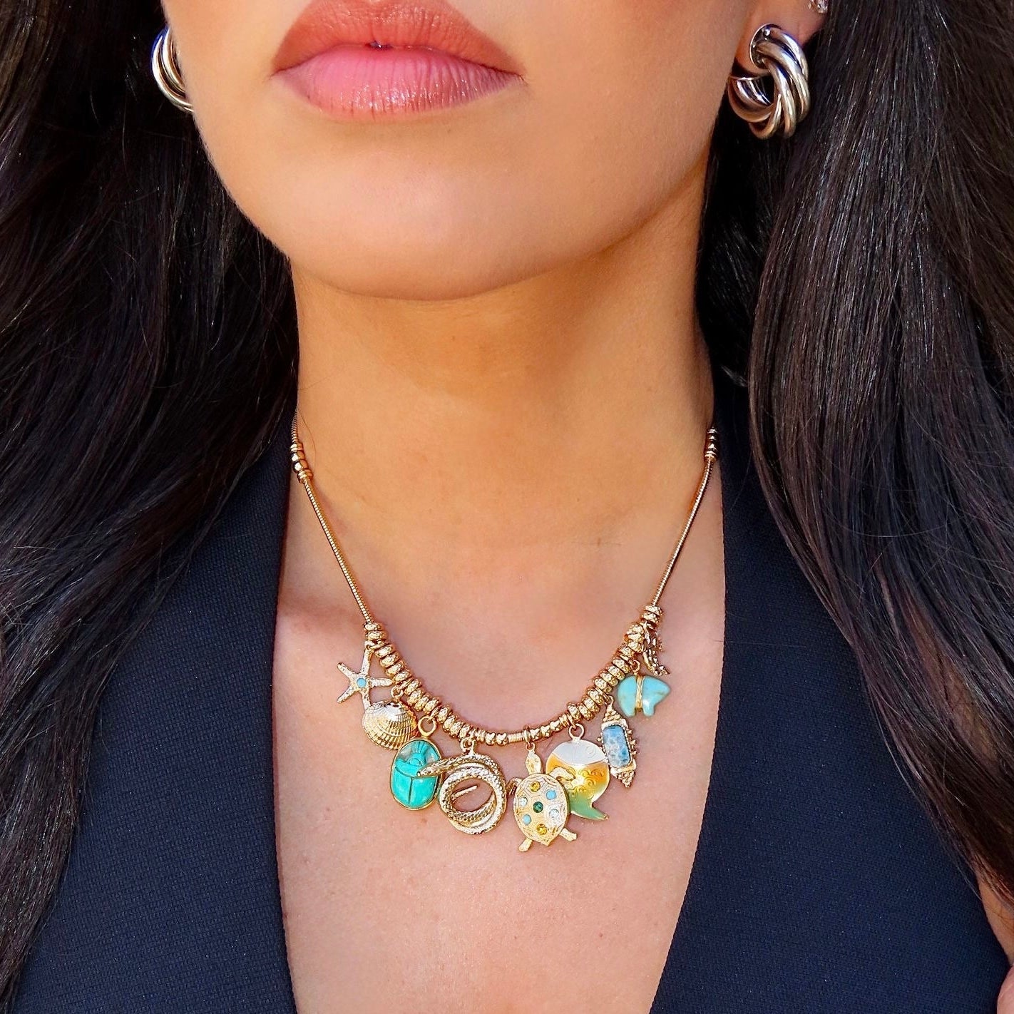 Necklace with colorful charms worn by a person