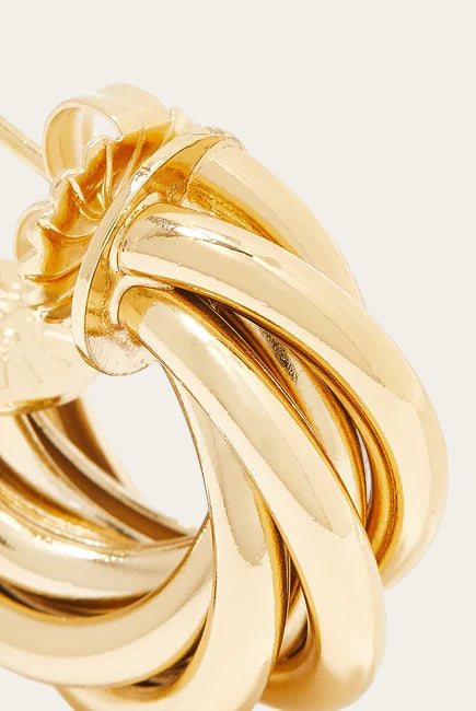 Gold knot-shaped earring on a white background