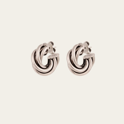Gas Bijoux Atik Mini silver-plated earrings with intertwined hoops, shown as a pair at an angle.