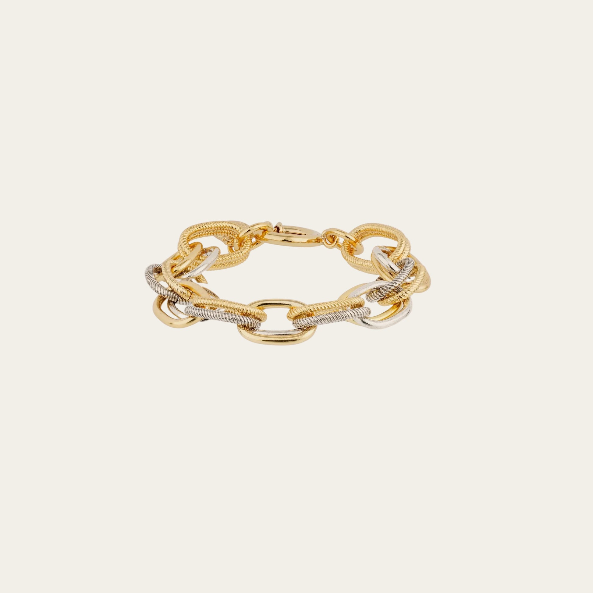 Gold chain bracelet on a light beige background