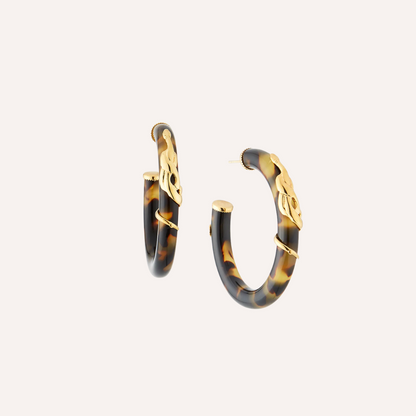 torte and gold hoop earrings on cream background