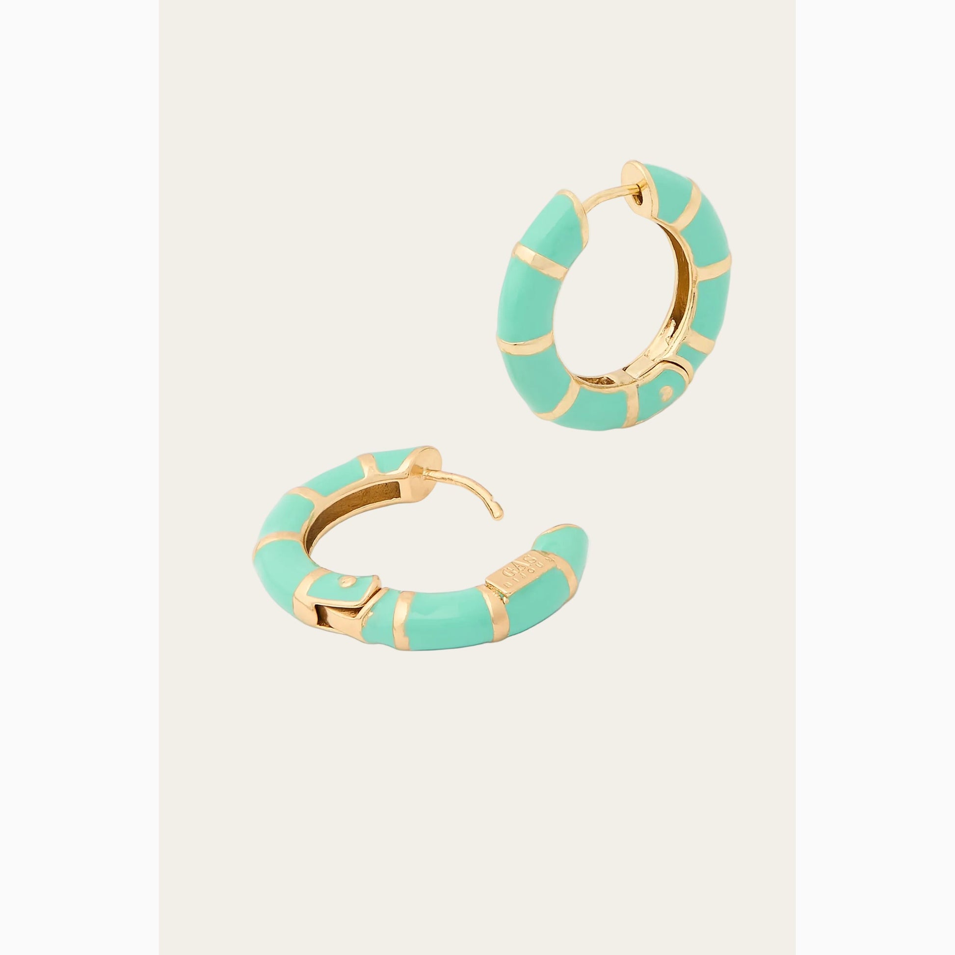 Pair of turquoise hoop earrings with gold accents on a white background