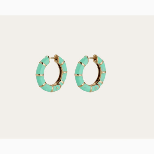 Turquoise hoop earrings with gold accents on a light gray background