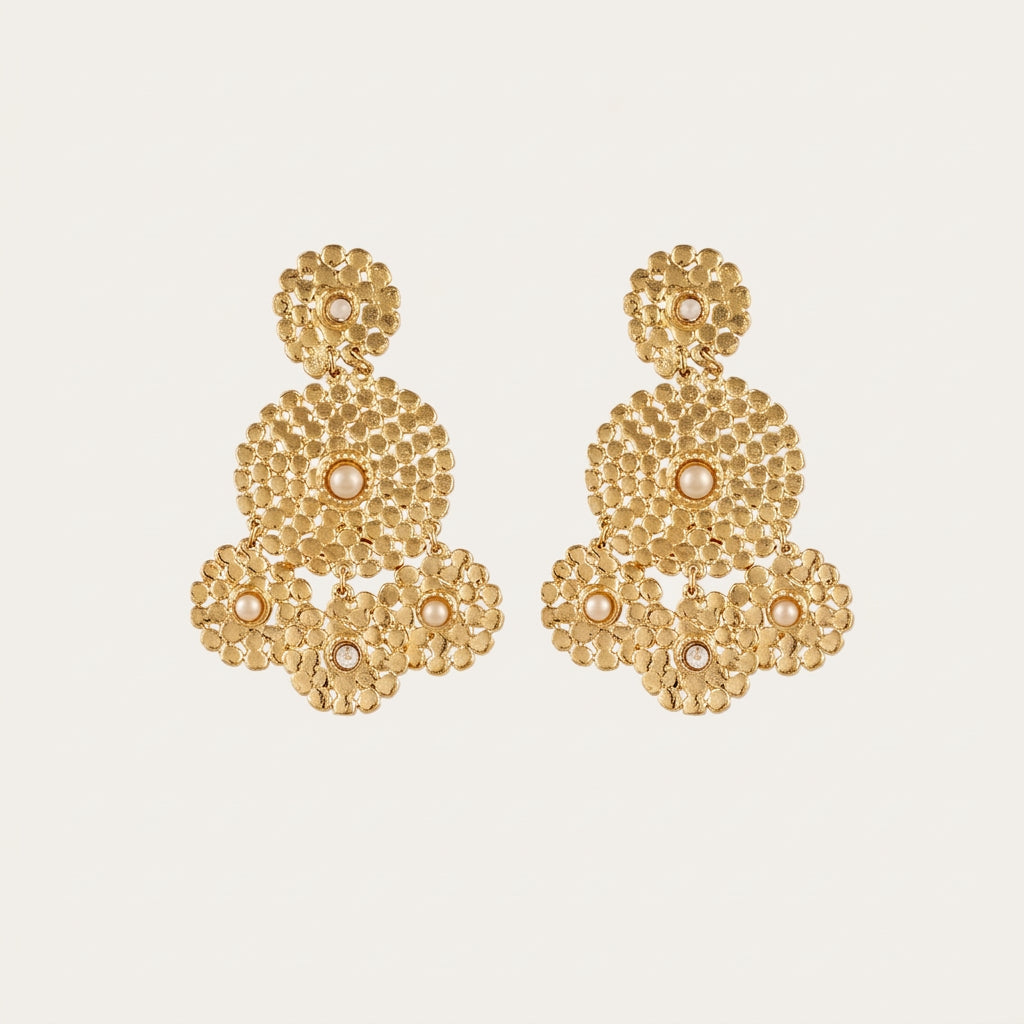 Pair of Gas Bijoux Lucky Sequin Cabochon gold-tone drop earrings with textured circular motifs on a cream background