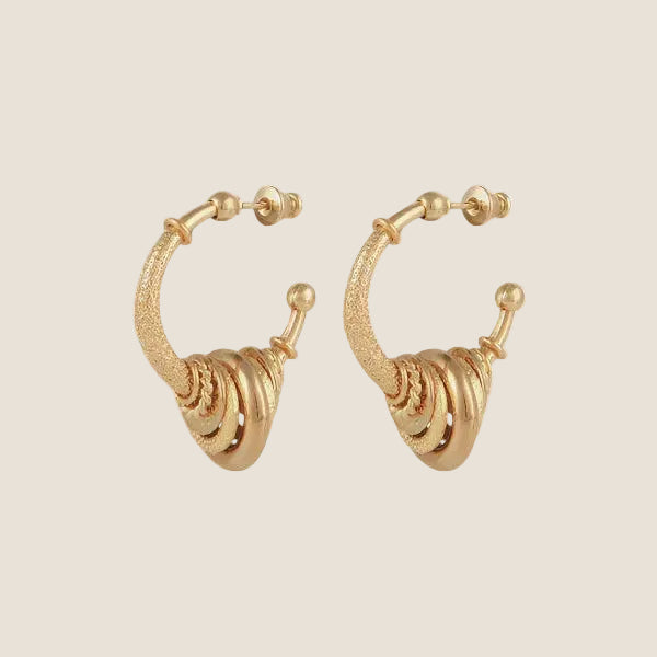 Gold plated hoops with little rings on beige background