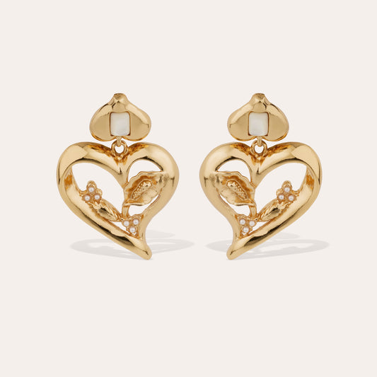 Gold love heart statement earrings with mother of pearl stones intertwined on cream background