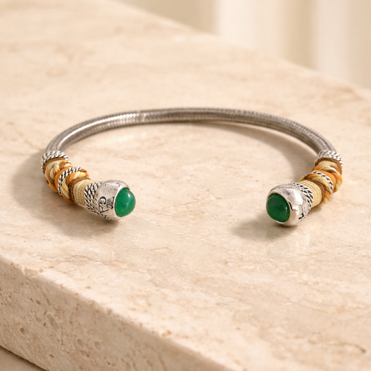 Silver Bangle with coloured threads on travertine