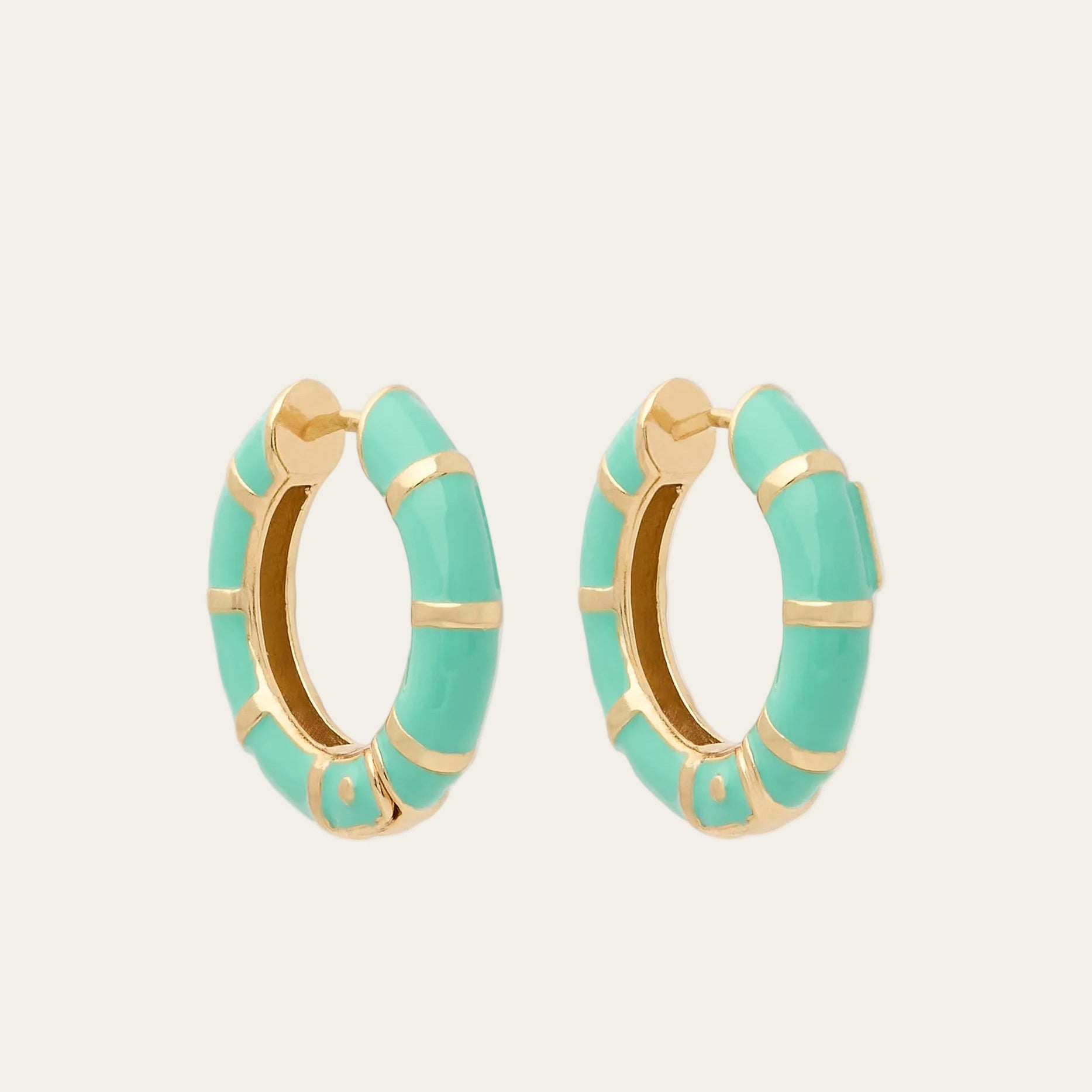 Turquoise hoop earrings with gold accents on a white background