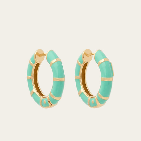 Turquoise hoop earrings with gold accents on a white background