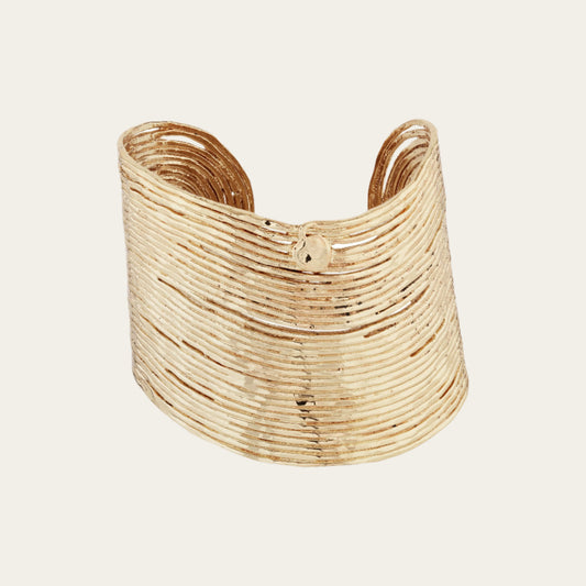 Gold plated wave bracelet on white background