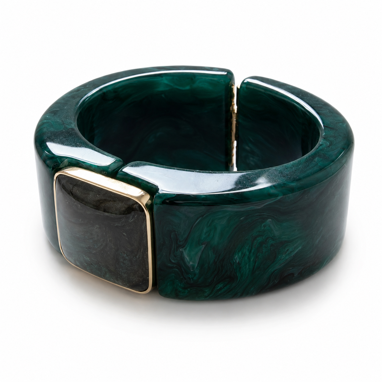 A wide, chunky bangle bracelet made of glossy dark green marbled resin, featuring a square black inset with a gold-tone border on the front, set against a plain white background.