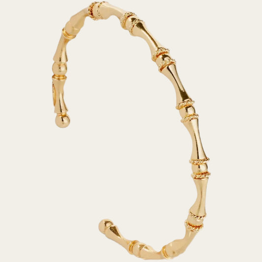 Gold bamboo-style ring on a white background