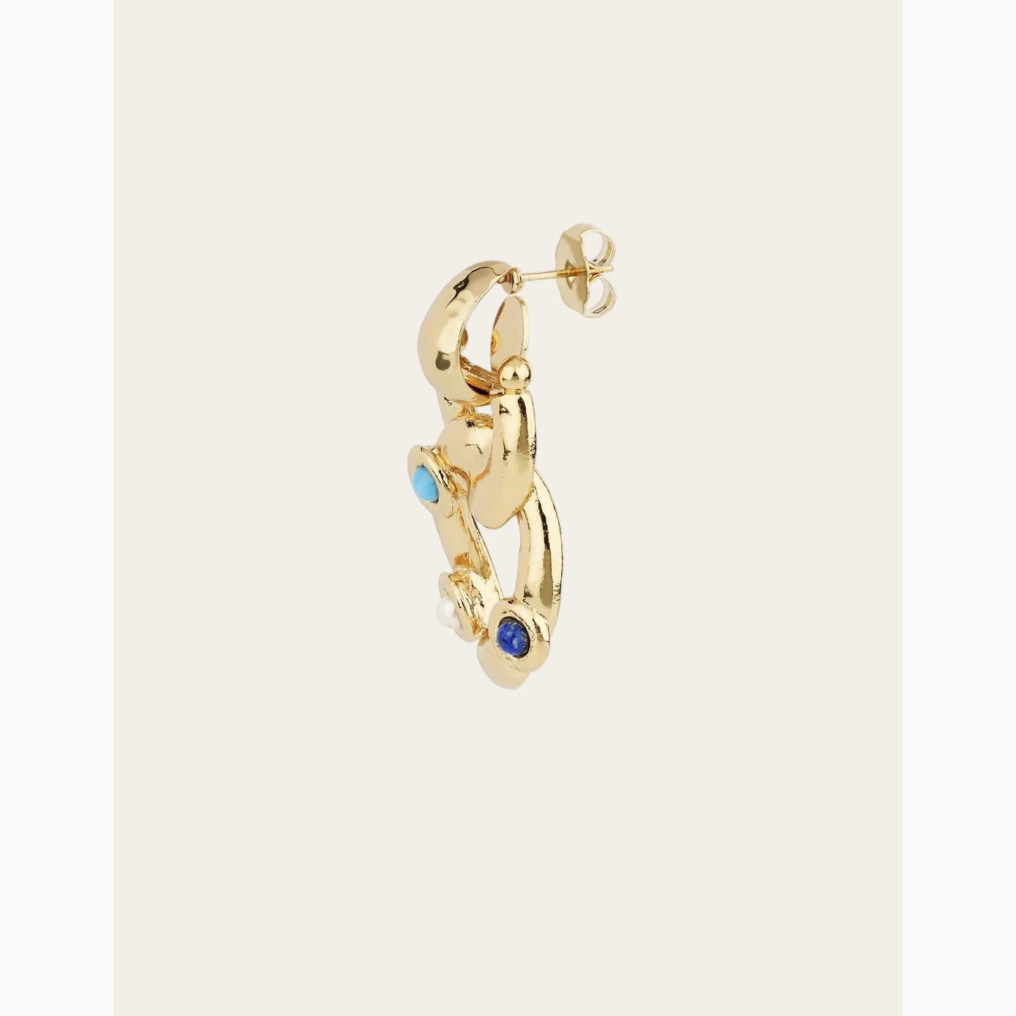 Gold hoop earring with blue gemstones on a white background