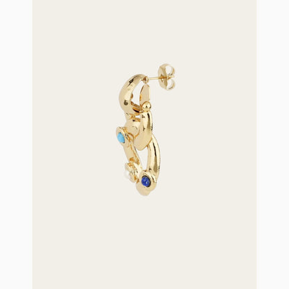 Gold hoop earring with blue gemstones on a white background