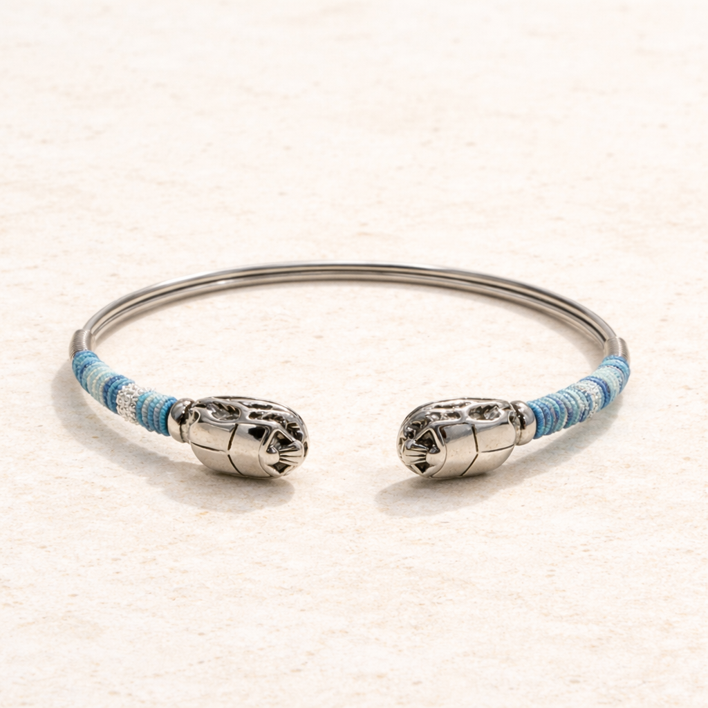 Silver bracelet with blue accents on a beige background