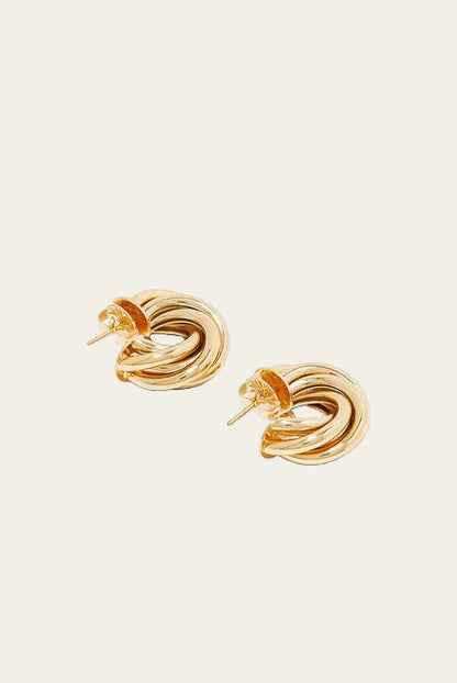 Pair of gold knot earrings on a white background