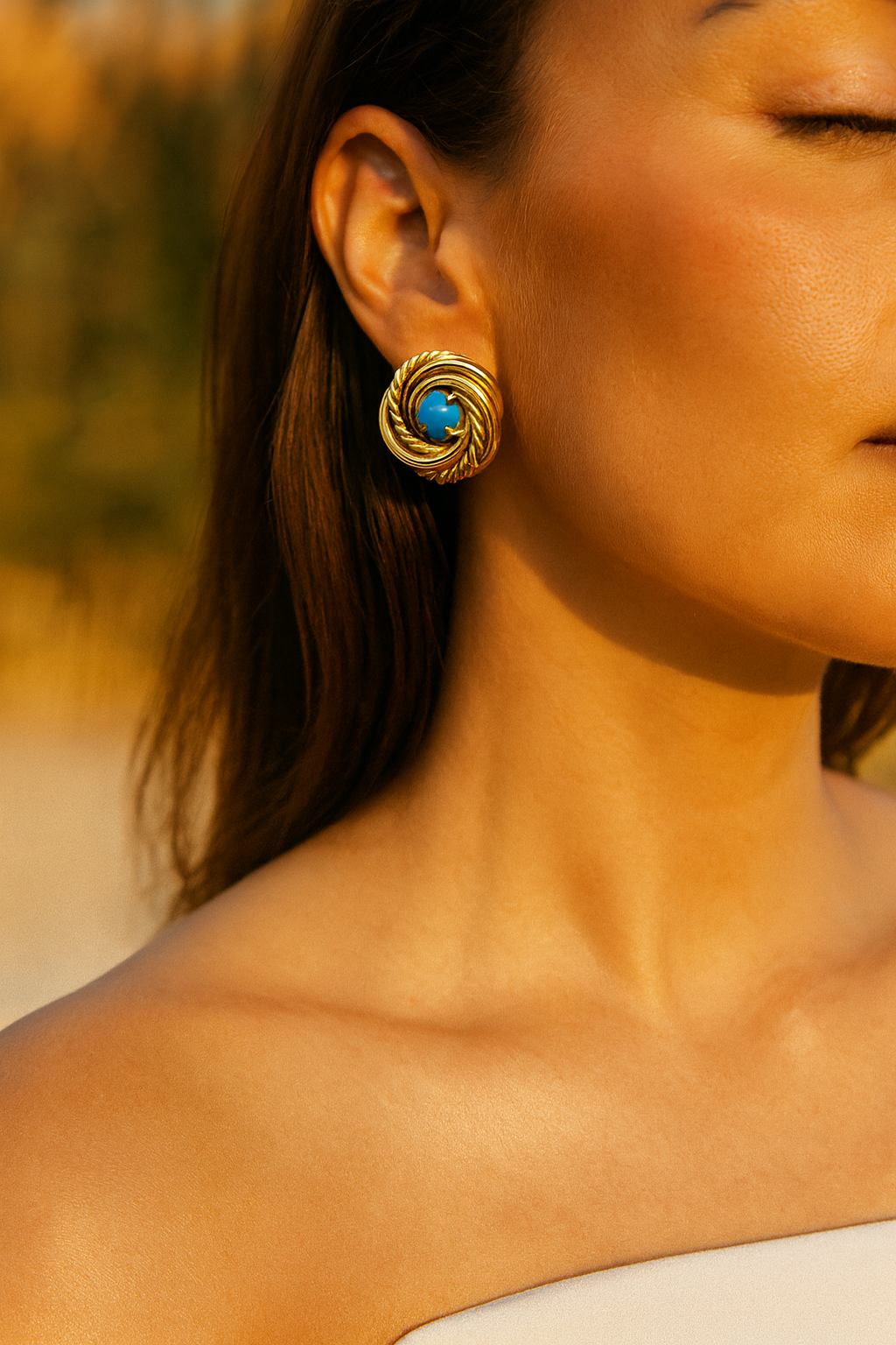 gold and turquoise earrings on woman at the artemis edit