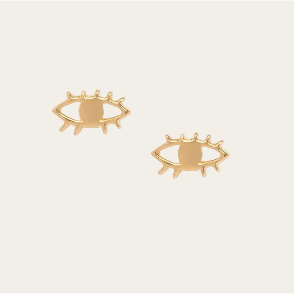 Gold eye-shaped earrings on a white background