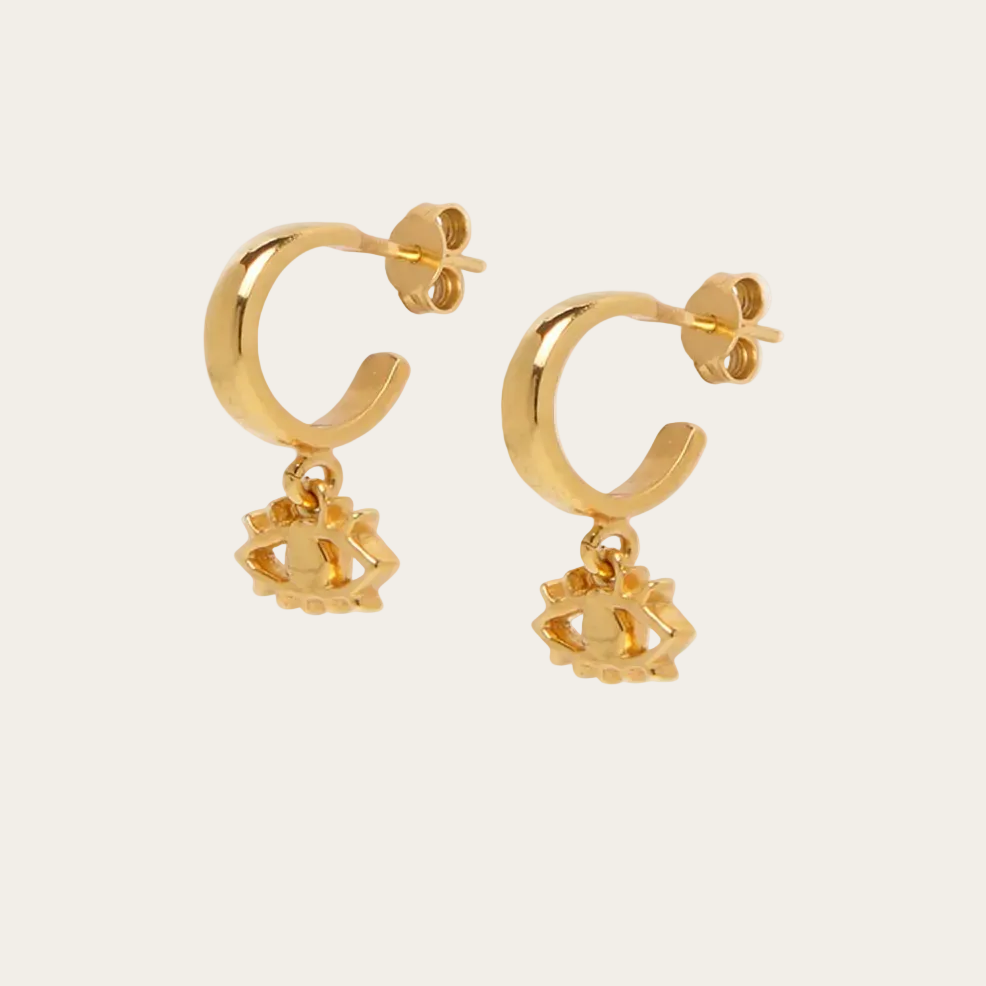 Gold hoop earrings with charms on a white background