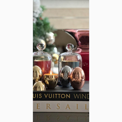 Omorfi metallic eff candles on coffee table with books.