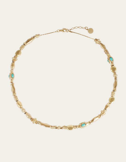 Gold necklace with turquoise stones on a white background