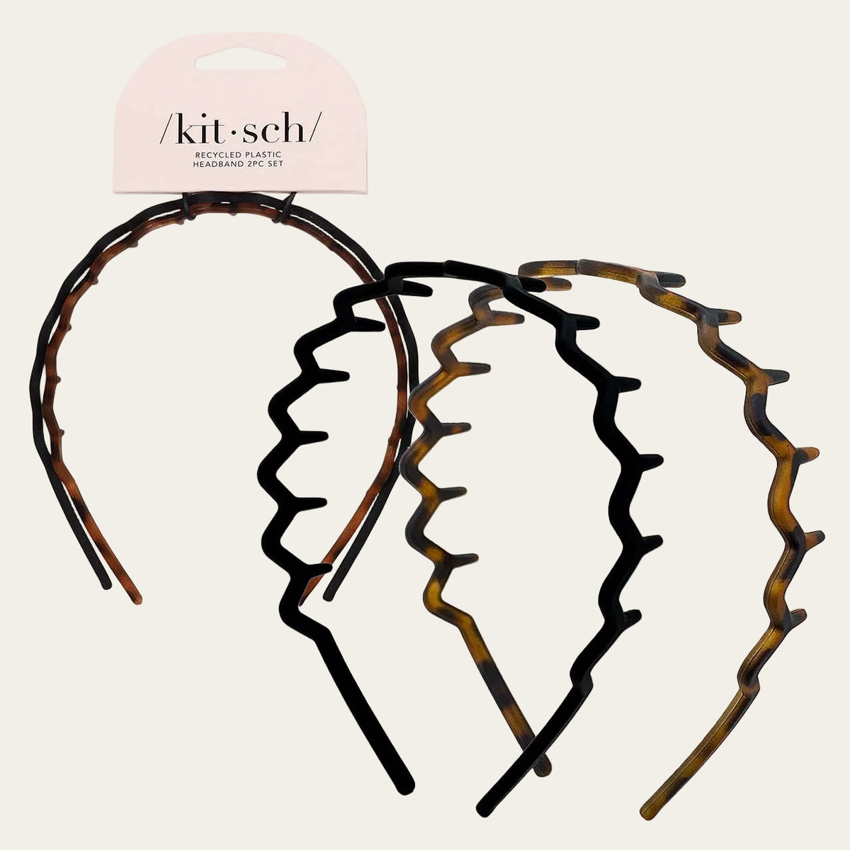 Set of tortoiseshell plastic headbands with 'kit-sch' packaging on a light gray background