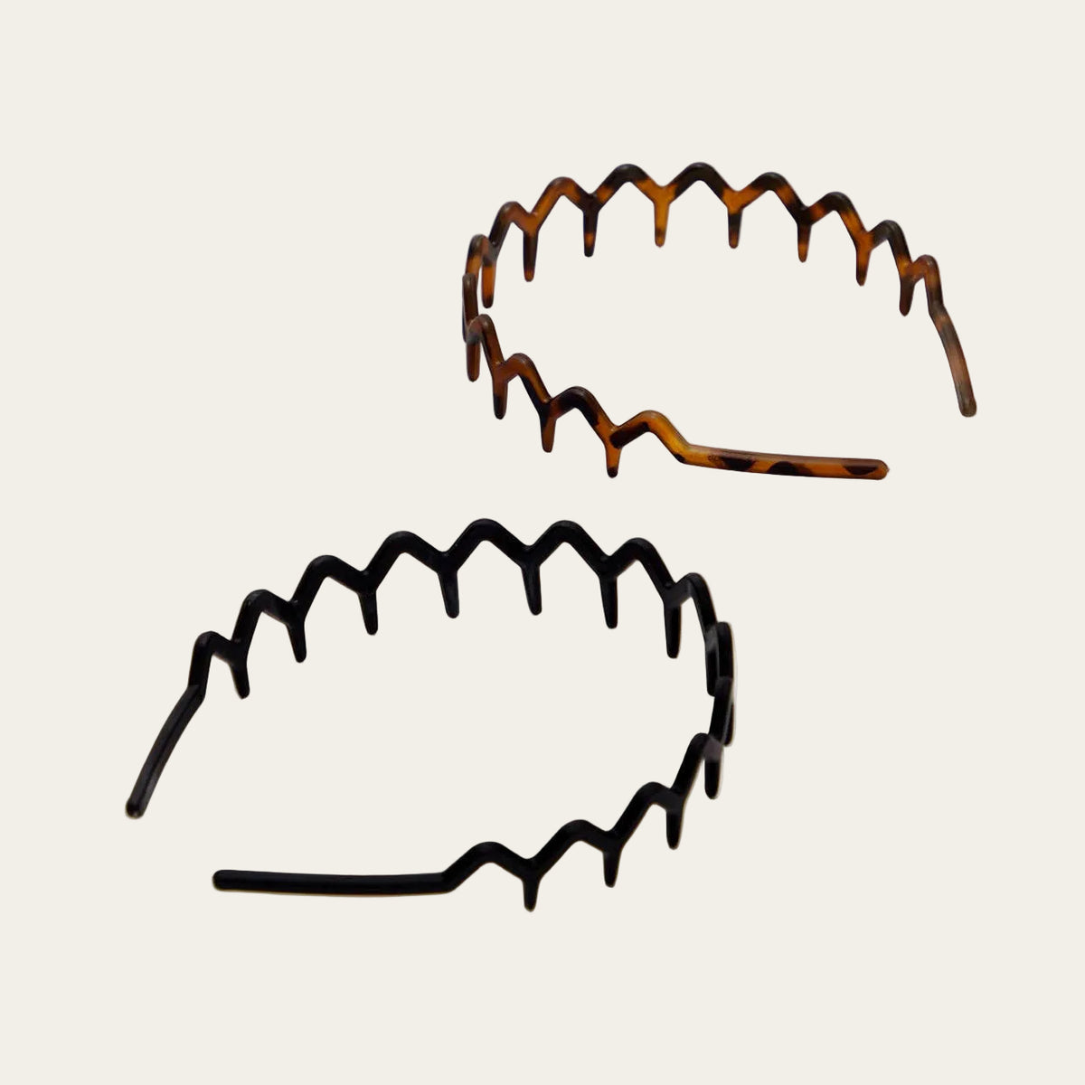Two tortoiseshell headbands on a light gray background